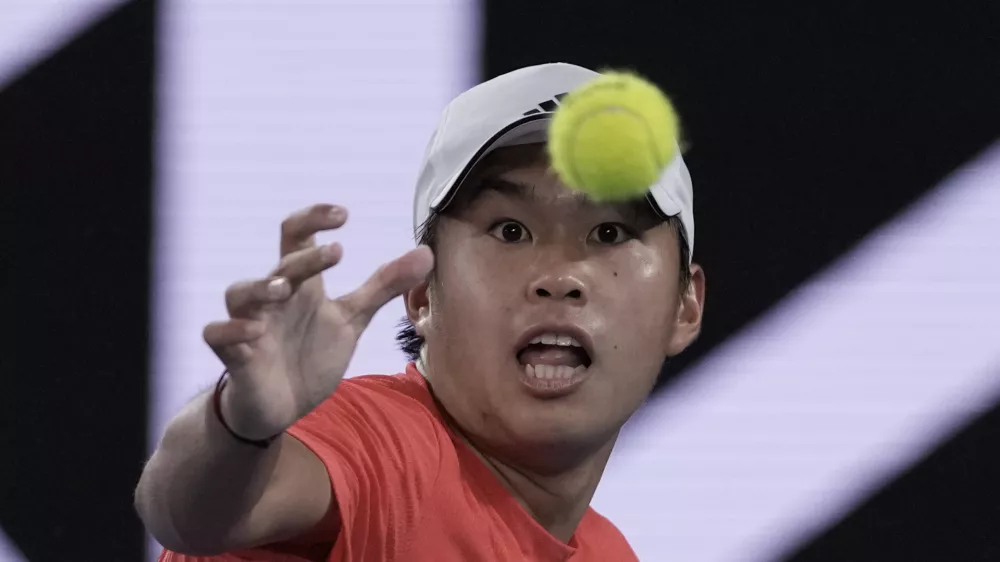 Learner Tien of the U.S. eyes the ball during his second round match against Daniil Medvedev of Russia at the Australian Open tennis championship in Melbourne, Australia, in the early hours of Friday, Jan. 17, 2025. (AP Photo/Ng Han Guan)