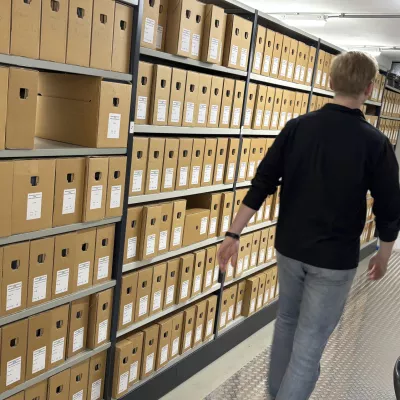 An archivist walks by file cabinets where documents, some regarding WWII collaboration, are stored at the NIOD Institute for War, Holocaust and Genocide Studies in Amsterdam, Netherlands, Friday, Jan. 10, 2025. (AP Photo/Aleks Furtula)