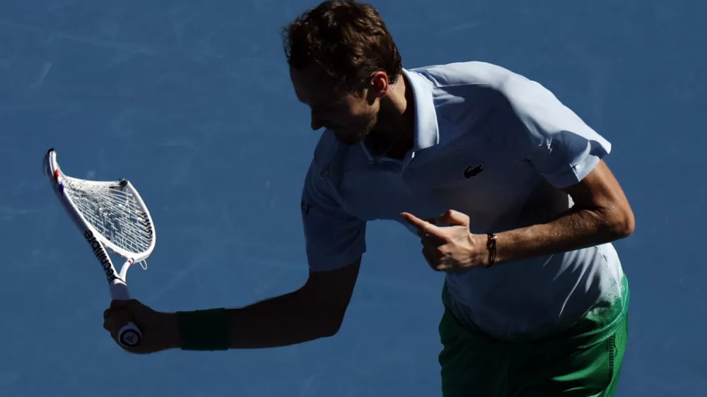 Tennis - Australian Open - Melbourne Park, Melbourne, Australia - January 14, 2025 Russia's Daniil Medvedev reacts while holding his smashed racquet during his first round match against Thailand's Kasidit Samrej REUTERS/Francis Mascarenhas