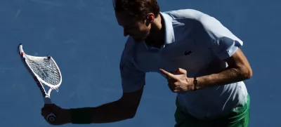 Tennis - Australian Open - Melbourne Park, Melbourne, Australia - January 14, 2025 Russia's Daniil Medvedev reacts while holding his smashed racquet during his first round match against Thailand's Kasidit Samrej REUTERS/Francis Mascarenhas