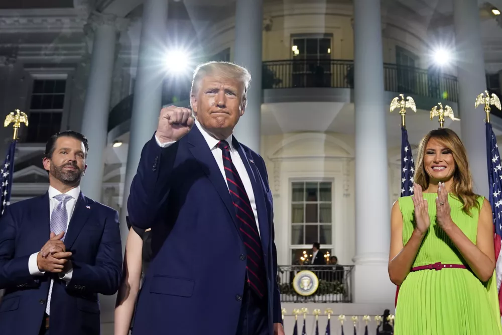 ﻿From left, Donald Trump Jr., President Donald Trump and first lady Melania Trump stand on the South Lawn of the White House on the fourth day of the Republican National Convention, Thursday, Aug. 27, 2020, in Washington. (AP Photo/Evan Vucci)