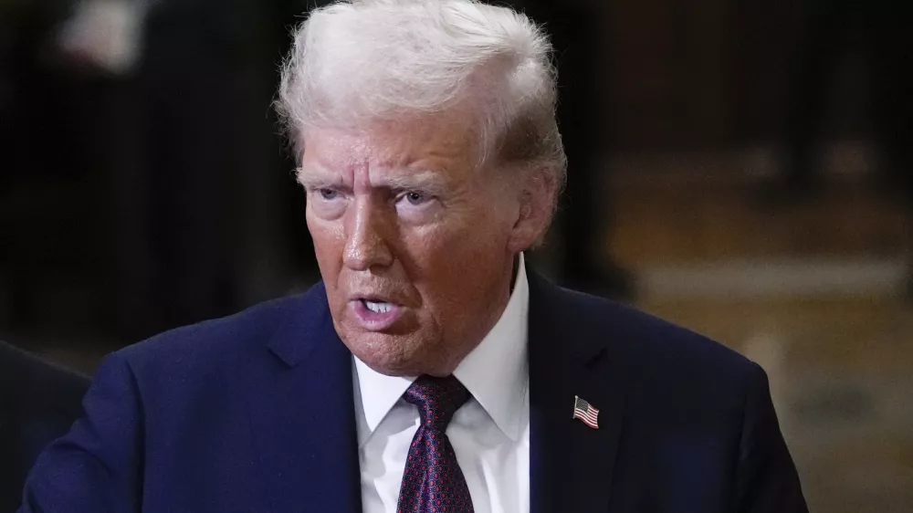 FILE - President-elect Donald Trump talks to reporters after a meeting with Republican leadership at the Capitol on Wednesday, Jan. 8, 2025, in Washington. (AP Photo/Steve Helber, File)