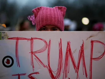 A woman wearing pink pussy protest hat poses for a photograph during the Women's March on Washington, following the inauguration of U.S. President Donald Trump, in Washington, DC, U.S. January 21, 2017.  REUTERS/Brian Snyder