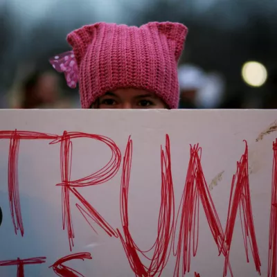 A woman wearing pink pussy protest hat poses for a photograph during the Women's March on Washington, following the inauguration of U.S. President Donald Trump, in Washington, DC, U.S. January 21, 2017.  REUTERS/Brian Snyder