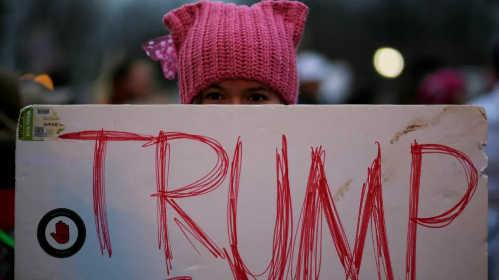 A woman wearing pink pussy protest hat poses for a photograph during the Women's March on Washington, following the inauguration of U.S. President Donald Trump, in Washington, DC, U.S. January 21, 2017.  REUTERS/Brian Snyder