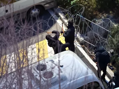 Police officers cut a wire fence set up at the entrance to the official residence of impeached South Korean President Yoon Suk Yeol, as authorities seek to execute an arrest warrant, in Seoul, South Korea, January 15, 2025.  Yonhap via REUTERS  THIS IMAGE HAS BEEN SUPPLIED BY A THIRD PARTY. NO RESALES. NO ARCHIVES. SOUTH KOREA OUT. NO COMMERCIAL OR EDITORIAL SALES IN SOUTH KOREA.   TPX IMAGES OF THE DAY