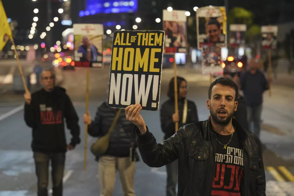 FILE - Israeli protesters call for Hamas to release hostages outside the Ministry of Defense headquarters in Tel Aviv, Israel, on Dec. 17, 2024. (AP Photo/Ariel Schalit, File)