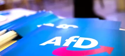 FILED - 24 November 2018, Bavaria, Greding: The far-right Alternative for Germany (AfD) flag placed on a table. The AfD party sent "deportation tickets" for "illegal immigrants" to mailboxes around the city of Karlsruhe, a local AfD official confirmed to dpa on 14 January. Photo: Daniel Karmann/dpa