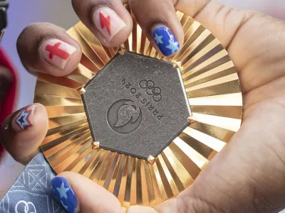 FILE - American Olympic champion Noah Lyles holds this gold medal before an interview in Paris, France, Sunday, Aug. 11, 2024. (AP Photo/Aurelien Morissard, File)