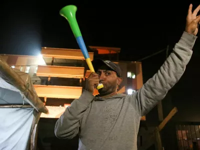 A Palestinian man reacts to news on a ceasefire deal with Israel, in Khan Younis in the southern Gaza Strip, January 15, 2025. REUTERS/Hatem Khaled REFILE - CORRECTING LOCATION FROM "DEIR AL-BALAH" TO "KHAN YOUNIS".