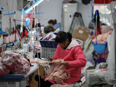 FILE PHOTO: Employees work on the production line at the Midnight Charm Garment lingerie factory in Guanyun county of Lianyungang, Jiangsu province, China November 25, 2024. REUTERS/Florence Lo/File Photo