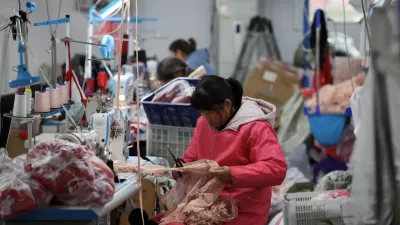 FILE PHOTO: Employees work on the production line at the Midnight Charm Garment lingerie factory in Guanyun county of Lianyungang, Jiangsu province, China November 25, 2024. REUTERS/Florence Lo/File Photo