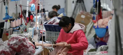 FILE PHOTO: Employees work on the production line at the Midnight Charm Garment lingerie factory in Guanyun county of Lianyungang, Jiangsu province, China November 25, 2024. REUTERS/Florence Lo/File Photo