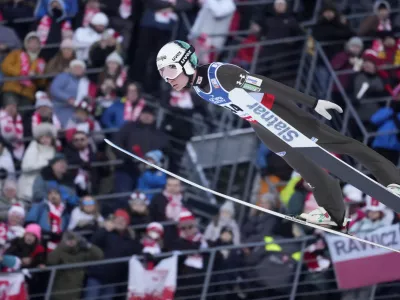 Anze Lanisek, of Slovenia, soars through the air during his trial jump at the Ski Jumping World Cup Men Large Hill Individual event in Zakopane, Poland, Sunday, Jan. 21, 2024. (AP Photo/Czarek Sokolowski)