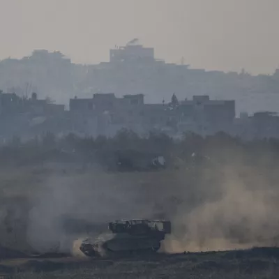 An Israeli army APC moves in the Gaza Strip as seen from southern Israel on Thursday, Jan. 16, 2025. (AP Photo/Ariel Schalit)