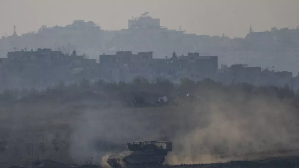 An Israeli army APC moves in the Gaza Strip as seen from southern Israel on Thursday, Jan. 16, 2025. (AP Photo/Ariel Schalit)