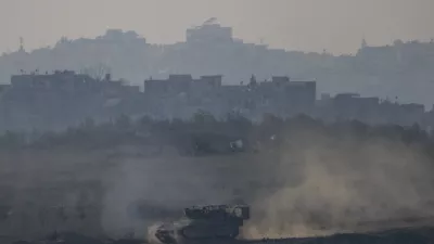 An Israeli army APC moves in the Gaza Strip as seen from southern Israel on Thursday, Jan. 16, 2025. (AP Photo/Ariel Schalit)