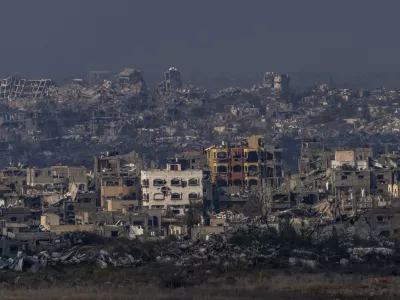 Destroyed buildings by Israeli bombardments as seen inside the Gaza Strip from southern Israel, Thursday, Jan. 16, 2025. (AP Photo/Ariel Schalit)