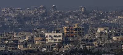 Destroyed buildings by Israeli bombardments as seen inside the Gaza Strip from southern Israel, Thursday, Jan. 16, 2025. (AP Photo/Ariel Schalit)