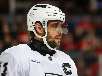 Jan 11, 2025; Calgary, Alberta, CAN; Los Angeles Kings center Anze Kopitar (11) during the face off against the Calgary Flames during the third period at Scotiabank Saddledome. Mandatory Credit: Sergei Belski-Imagn Images