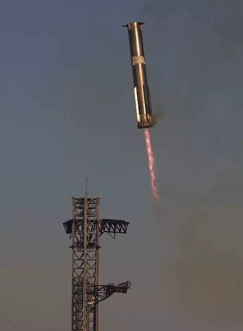 SpaceX's mega rocket Starship booster returns to the launch pad during a test flight from Starbase in Boca Chica, Texas, Thursday, Jan. 16, 2025. (AP Photo/Eric Gay)