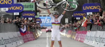 Reigning World Champion Slovenia's Tadej Pogacar holds up his bike as he celebrates winning Il Lombardia, Tour of Lombardy cycling race, in Como, Italy, Saturday, Oct. 12, 2024. (Gian Mattia D'Alberto/LaPresse via AP)