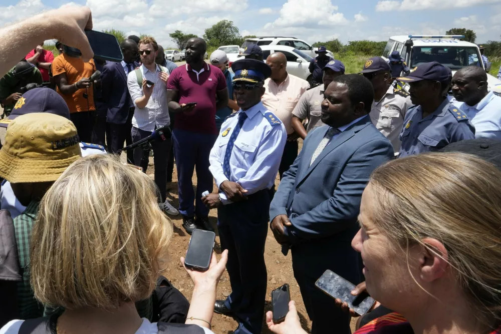 The Acting Provincial Commissioner of North West, Major General Patrick Asaneng, centre, speaks to journalists outside an abandoned gold mine, where miners were rescued from below ground, in Stilfontein, South Africa, Thursday, Jan. 16, 2025. (AP Photo/Themba Hadebe)