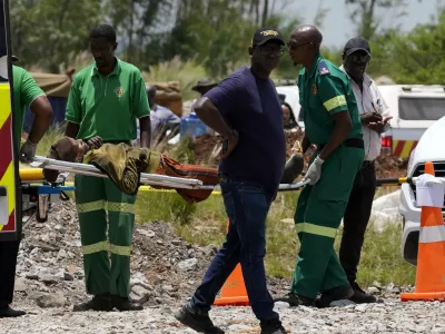 A miner is transported on a stretcher by rescue workers after he was rescued from below ground in an abandoned gold mine in Stilfontein, South Africa, Tuesday, Jan. 14, 2025. (AP Photo/Themba Hadebe)