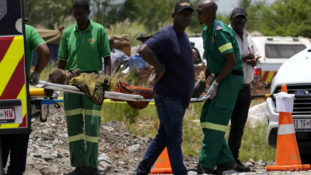 A miner is transported on a stretcher by rescue workers after he was rescued from below ground in an abandoned gold mine in Stilfontein, South Africa, Tuesday, Jan. 14, 2025. (AP Photo/Themba Hadebe)