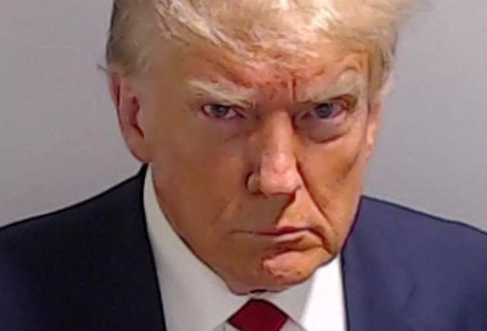 FILE PHOTO: Former U.S. President Donald Trump is shown in a police booking mugshot released by the Fulton County Sheriff's Office, after a Grand Jury brought back indictments against him and 18 of his allies in their attempt to overturn the state's 2020 election results in Atlanta, Georgia, U.S., August 24, 2023. Fulton County Sheriff's Office/Handout via REUTERS THIS IMAGE HAS BEEN SUPPLIED BY A THIRD PARTY. THIS PICTURE WAS PROCESSED BY REUTERS TO ENHANCE QUALITY. AN UNPROCESSED VERSION HAS BEEN PROVIDED SEPARATELY./File Photo