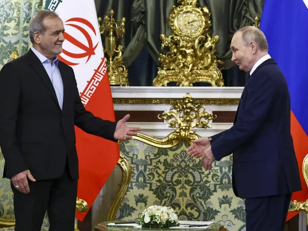 Russian President Vladimir Putin, right, and Iranian President Masoud Pezeshkian arrive to attend talks at the Kremlin in Moscow, Russia, Friday, Jan. 17, 2025. (Evgenia Novozhenina/Pool Photo via AP)