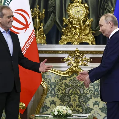 Russian President Vladimir Putin, right, and Iranian President Masoud Pezeshkian arrive to attend talks at the Kremlin in Moscow, Russia, Friday, Jan. 17, 2025. (Evgenia Novozhenina/Pool Photo via AP)