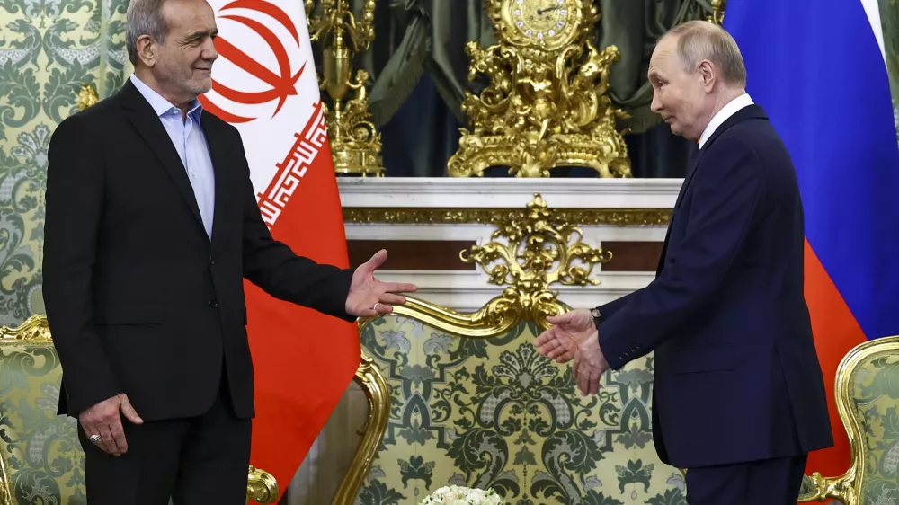 Russian President Vladimir Putin, right, and Iranian President Masoud Pezeshkian arrive to attend talks at the Kremlin in Moscow, Russia, Friday, Jan. 17, 2025. (Evgenia Novozhenina/Pool Photo via AP)