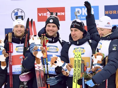 The winning French relay team from left, Emilien Claude, Fabien Claude, Quentin Fillon Maillet and Emilien Jacquelin celebrate on the podium after the men's relay 4 x 7.5 km at the Biathlon World Cup in Ruhpolding, Germany, Friday Jan. 17, 2025. (Sven Hoppe/dpa via AP)