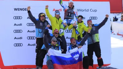 Slovenia's Miha Hrobat, center top, celebrates on the podium with his team after taking third place in an alpine ski, men's World Cup downhill, in Wengen, Switzerland, Saturday, Jan. 18, 2025. (AP Photo/Giovanni Maria Pizzato)