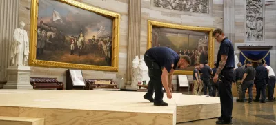 Workers build a stage in the U.S. Capitol Rotunda in Washington Friday, Jan. 17, 2025, for the 60th Presidential Inauguration which was moved indoors because of cold temperatures expected on Jan 20. (AP Photo/Morry Gash)