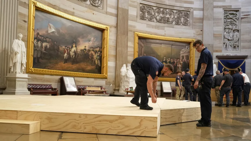 Workers build a stage in the U.S. Capitol Rotunda in Washington Friday, Jan. 17, 2025, for the 60th Presidential Inauguration which was moved indoors because of cold temperatures expected on Jan 20. (AP Photo/Morry Gash)