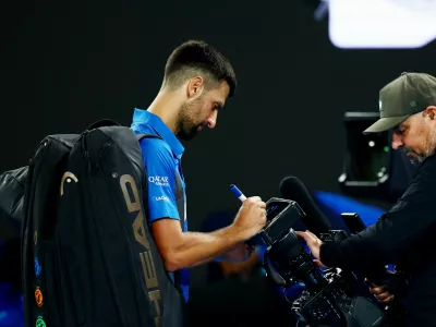 Tennis - Australian Open - Melbourne Park, Melbourne, Australia - January 17, 2025 Serbia's Novak Djokovic can be seen writing a message on a tv camera after his third round match against Czech Republic's Tomas Machac REUTERS/Edgar Su