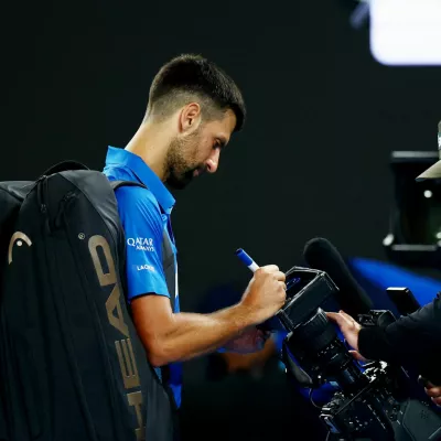 Tennis - Australian Open - Melbourne Park, Melbourne, Australia - January 17, 2025 Serbia's Novak Djokovic can be seen writing a message on a tv camera after his third round match against Czech Republic's Tomas Machac REUTERS/Edgar Su