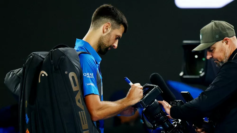 Tennis - Australian Open - Melbourne Park, Melbourne, Australia - January 17, 2025 Serbia's Novak Djokovic can be seen writing a message on a tv camera after his third round match against Czech Republic's Tomas Machac REUTERS/Edgar Su