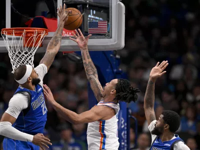 Jan 17, 2025; Dallas, Texas, USA; Dallas Mavericks center Daniel Gafford (21) blocks a shot by Oklahoma City Thunder forward Jaylin Williams (6) during the second half at the American Airlines Center. Mandatory Credit: Jerome Miron-Imagn Images