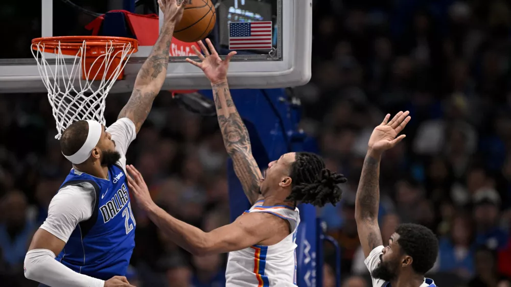 Jan 17, 2025; Dallas, Texas, USA; Dallas Mavericks center Daniel Gafford (21) blocks a shot by Oklahoma City Thunder forward Jaylin Williams (6) during the second half at the American Airlines Center. Mandatory Credit: Jerome Miron-Imagn Images