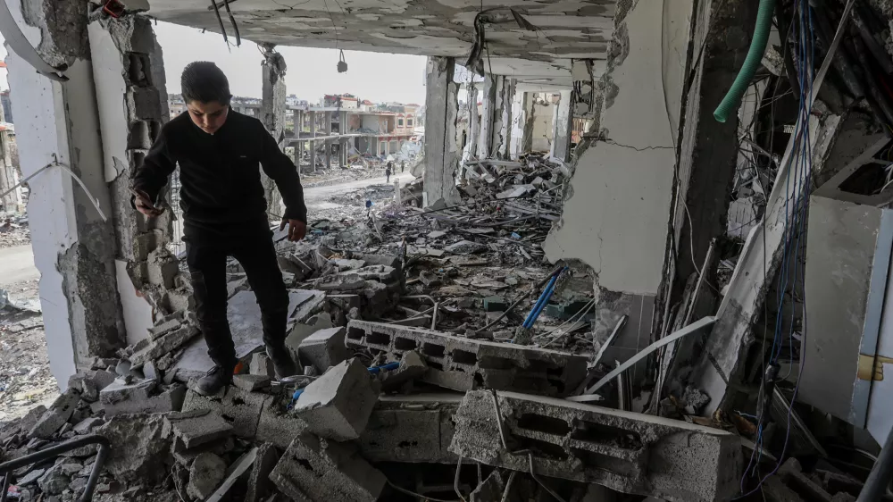 20 January 2025, Palestinian Territories, Rafah: A Palestinian boy inspects the rubble inside Abu Yousef Al-Najjar Hospital, which was destroyed by the Israeli army in the southern Gaza Strip city of Rafah, amid a ceasefire deal between Israel and Hamas. Photo: Abed Rahim Khatib/dpa