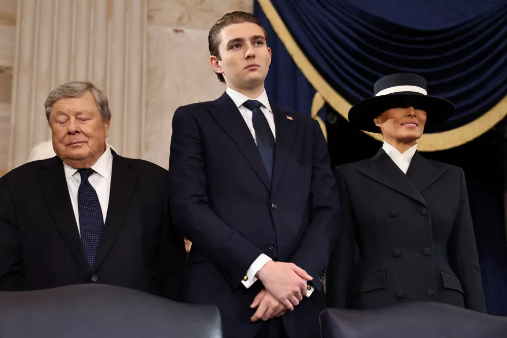 WASHINGTON, DC - JANUARY 20: (L-R) Viktor Knavs, Barron Trump and Melania Trump attend the inauguration of U.S. President-elect Donald Trump in the Rotunda of the U.S. Capitol on January 20, 2025 in Washington, DC. Donald Trump takes office for his second term as the 47th president of the United States.  Chip Somodevilla/Pool via REUTERS