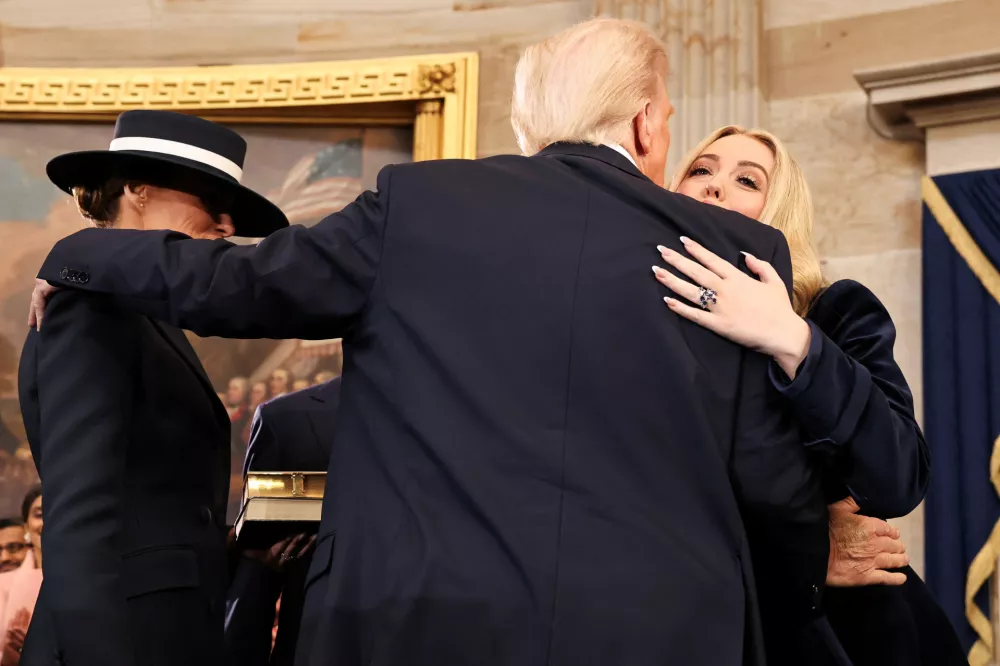 WASHINGTON, DC - JANUARY 20: U.S. President Donald Trump embraces Melania Trump (L) and Tiffany Trump after being sworn in during inauguration ceremonies in the Rotunda of the U.S. Capitol on January 20, 2025 in Washington, DC. Donald Trump takes office for his second term as the 47th president of the United States.  Chip Somodevilla/Pool via REUTERS