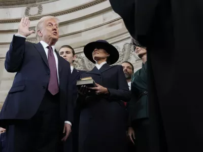 Donald Trump is sworn in as the 47th president of the United States by Chief Justice John Roberts as Melania Trump holds the Bible during the 60th Presidential Inauguration in the Rotunda of the U.S. Capitol in Washington, Monday, Jan. 20, 2025. (AP Photo/Morry Gash, Pool)