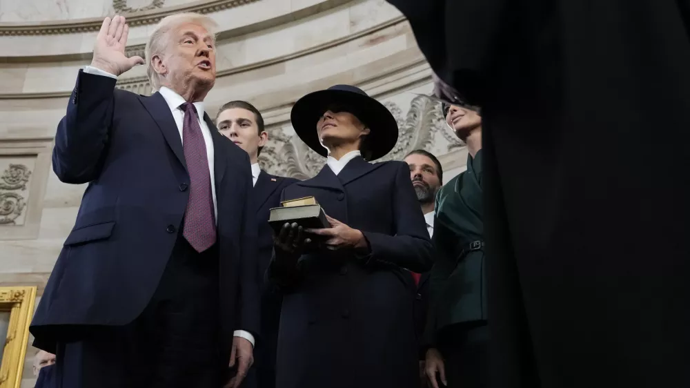 Donald Trump is sworn in as the 47th president of the United States by Chief Justice John Roberts as Melania Trump holds the Bible during the 60th Presidential Inauguration in the Rotunda of the U.S. Capitol in Washington, Monday, Jan. 20, 2025. (AP Photo/Morry Gash, Pool)