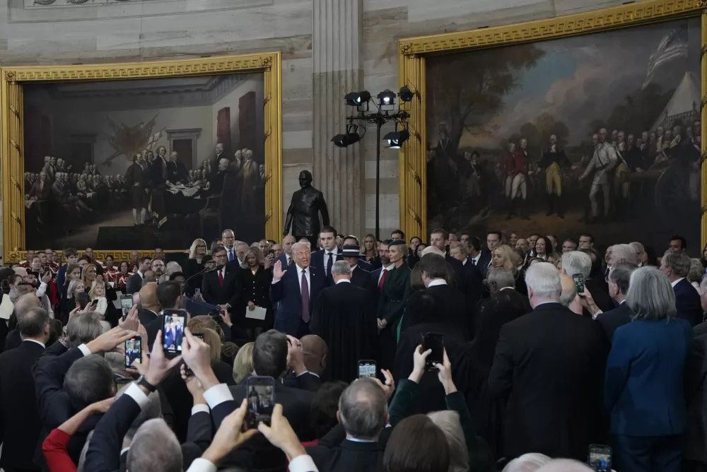 Donald Trump is sworn in as the 47th president of the United States by Chief Justice John Roberts as Melania Trump holds the Bible during the 60th Presidential Inauguration in the Rotunda of the U.S. Capitol in Washington, Monday, Jan. 20, 2025. (AP Photo/Julia Demaree Nikhinson, Pool)