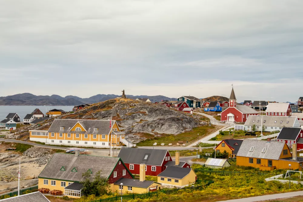 Colorful houses with the school Det gamle Sygehus, the cathedral and the statue of Hans Egede in the background, Nuuk, Greenland.