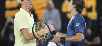 Jannik Sinner, left, of Italy is congratulated by Alex de Minaur of Australia following their quarterfinal match at the Australian Open tennis championship in Melbourne, Australia, Wednesday, Jan. 22, 2025. (AP Photo/Vincent Thian)